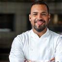 Chef Marcus Lee in chef whites, arms crossed