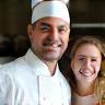 Smiling chef and satisfied client in event kitchen